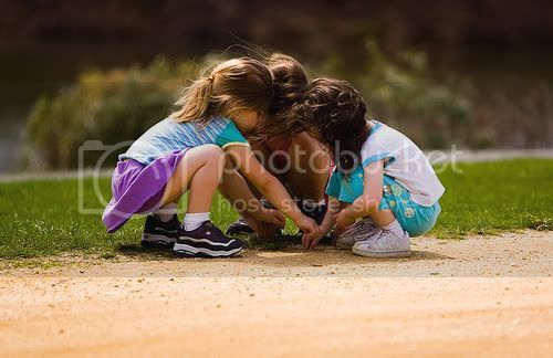 three girls playing in the dirt