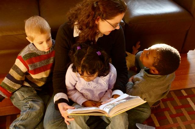 mom reading to three kids